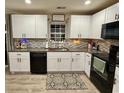 Bright kitchen with white cabinets, black appliances, granite countertops, and stainless steel sink at 276 Palmetto Glen Dr., Myrtle Beach, SC 29588