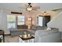 Cozy living room with a large sectional sofa, ceiling fan, and plenty of natural light at 276 Palmetto Glen Dr., Myrtle Beach, SC 29588