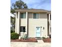 Attractive condo featuring a quaint patio area with a table and a charming blue door at 951 Plantation Dr. # F1, Little River, SC 29566