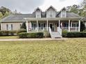 Inviting home with a classic front porch, complemented by well-kept landscaping and dormer windows at 2347 Devine St., Georgetown, SC 29440