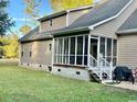Rear view of the home showing a screened in porch, backyard, and concrete slab foundation at 2347 Devine St., Georgetown, SC 29440