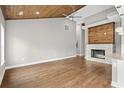 Spacious living room with a wooden ceiling, hardwood floors, and a modern fireplace at 428 Meadow View Ct., Longs, SC 29568