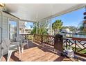 Cozy covered deck with a waterfront view, equipped with outdoor seating and a grill for entertaining at 6001-S32 S Kings Hwy., Myrtle Beach, SC 29575