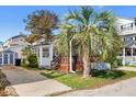 Charming home featuring a well-maintained lawn, a covered porch, and a convenient paved driveway at 6001-S32 S Kings Hwy., Myrtle Beach, SC 29575