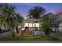 Charming single-story home featuring a large front porch, well-kept lawn, and a mature palm tree at 6001-S32 S Kings Hwy., Myrtle Beach, SC 29575