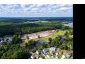Expansive aerial view showcasing the community's beautiful surroundings, including ponds, golf course, and wooded areas at 9746 Indigo Creek Blvd., Murrells Inlet, SC 29576