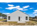 Rear exterior view of the house, showing the white siding and door to the outside at 1534 Clubstone Dr., Conway, SC 29526