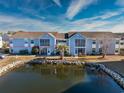 Aerial view of condo showing building and pond at 2257 Essex Dr. # E, Surfside Beach, SC 29575