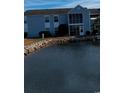 Condo building with water view and landscaping at 2257 Essex Dr. # E, Surfside Beach, SC 29575