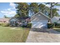 Charming single-story home featuring a well-manicured lawn and an attached two-car garage at 603 Bucks Trail, Longs, SC 29568