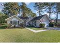 Well-maintained single-story home boasting a lush lawn and a convenient two-car garage at 603 Bucks Trail, Longs, SC 29568