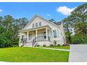 Beautiful exterior elevation with inviting porch, detailed trim, and manicured landscaping at 805 Comanders Island Rd., Georgetown, SC 29440