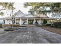 Spacious home with a columned front porch, rocking chairs, and a large driveway at 805 Comanders Island Rd., Georgetown, SC 29440