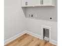 Laundry area with laminate flooring and utility sink hookups at 805 Comanders Island Rd., Georgetown, SC 29440