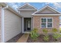 Front entrance with stone and siding exterior at 808 Flowering Branch Ave., Little River, SC 29566