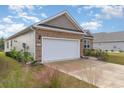 Two-car garage with stone and siding exterior at 808 Flowering Branch Ave., Little River, SC 29566