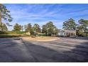 Community entrance with a fountain, lush landscaping, and guard house at 852 Comanders Island Rd., Georgetown, SC 29440