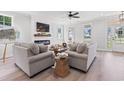 Inviting living room featuring neutral furniture, a woven coffee table, and sun-drenched windows at 852 Comanders Island Rd., Georgetown, SC 29440
