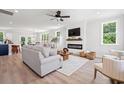 Bright living room with modern fireplace, hardwood floors, ceiling fan, and ample natural light at 852 Comanders Island Rd., Georgetown, SC 29440