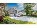 Charming two-story home with brick accents, well-manicured lawn, and a spacious driveway at 1010 Club House Dr., North Myrtle Beach, SC 29582