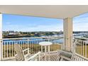 Relaxing balcony with outdoor seating overlooks the beautiful intercoastal waterway, offering scenic views at 2151 Bridge View Ct. # 2502, North Myrtle Beach, SC 29582