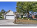 Inviting single-story home with a well-kept lawn and a spacious two-car garage at 565 Bucks Trail, Longs, SC 29568