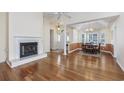 Bright living room featuring hardwood floors, a fireplace, and an open dining area at 565 Bucks Trail, Longs, SC 29568