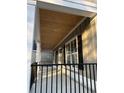 Covered porch featuring black railings, white pillars, and a tongue and groove ceiling at 1006 Cuttino St., Georgetown, SC 29440