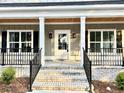 Lovely entryway featuring a bright white door, and black railings to the steps at 1006 Cuttino St., Georgetown, SC 29440