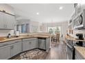 Bright kitchen featuring gray cabinets, granite counters, and stainless steel appliances at 131 Grissett Lake Dr., Conway, SC 29526
