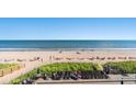 Scenic beach view from a deck with lounge chairs and tables at 2311 S Ocean Blvd. # 438, Myrtle Beach, SC 29577