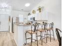 Bright kitchen featuring stainless steel appliances, white cabinetry, and a breakfast bar with seating at 601 Hillside Dr. N # 4133, North Myrtle Beach, SC 29582