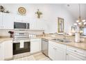 The kitchen features stainless steel appliances, white cabinets, and granite countertops, offering modern appeal at 601 Hillside Dr. N # 4133, North Myrtle Beach, SC 29582