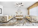 Bright living room with luxury furnishings and a statement ceiling fan at 656 Pistoia Ln. # 304, Myrtle Beach, SC 29579