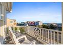 Oceanfront balcony with white chairs and scenic view at 870 Ocean Blvd., Holden Beach, NC 28462