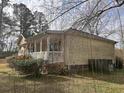 Side view of a cozy house with a screened porch and mature landscaping at 1237 Spring Garden Rd., Conway, SC 29526