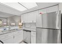 Modern kitchen with white cabinets, granite countertops, and stainless steel appliances at 23 Shadow Moss Pl. # 23, North Myrtle Beach, SC 29582