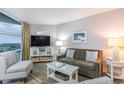 Cozy living room with stylish furnishings, lamps, and a window with natural light at 2301 S Ocean Blvd. # 1408, North Myrtle Beach, SC 29582