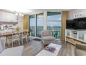 Bright living room featuring a comfortable sitting area, balcony access, and ocean views at 2301 S Ocean Blvd. # 1408, North Myrtle Beach, SC 29582