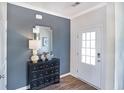 Stylish entryway featuring a black accent wall, decorative mirror, and elegant black dresser with decorative accents at 873 Agostino Dr., Myrtle Beach, SC 29579