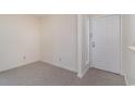 Unfurnished living room with neutral carpet and a white front door offers a blank canvas at 1356 Glenns Bay Rd. # 207-J, Surfside Beach, SC 29575