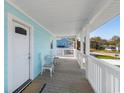 Charming front porch with white railings and seating area at 243 Calhoun Dr., Garden City Beach, SC 29576