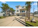 Inviting elevated beach home with a garage and a well-maintained driveway at 302A 32Nd Ave. N, North Myrtle Beach, SC 29582
