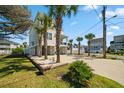 Side view of beach home with a large driveway and manicured landscaping at 302A 32Nd Ave. N, North Myrtle Beach, SC 29582