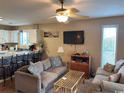 Comfortable living room with a ceiling fan, a flat-screen TV, and neutral-toned furniture at 1095 West Plantation Dr. # 28-I, Little River, SC 29566