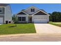 New single-Gathering home featuring a spacious lawn, two-car garage, and stone facade at 110 Arrow Wood Dr, Conway, SC 29526