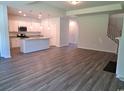 Open-concept living room featuring wood-look floors and an island kitchen with stainless steel appliances at 110 Arrow Wood Dr, Conway, SC 29526