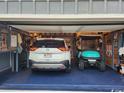 Well-organized garage featuring storage solutions, a car, and a golf cart at 2256 Heritage Loop # 2256, Myrtle Beach, SC 29577