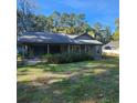 Gray house with a covered porch and green lawn at 354 George Washington Trail, Georgetown, SC 29440