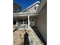 Front entrance with a covered porch and white door at 4650 Quiet Ave., Conway, SC 29527